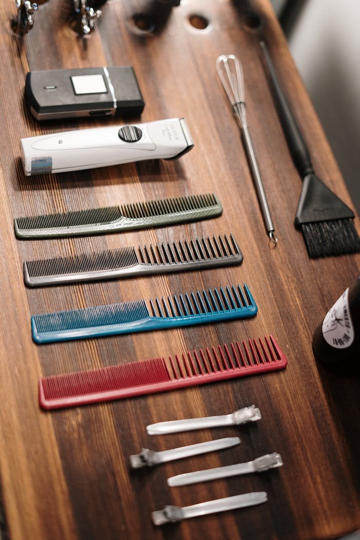 Home Organized collection of barber tools on a wooden table, ready for grooming.