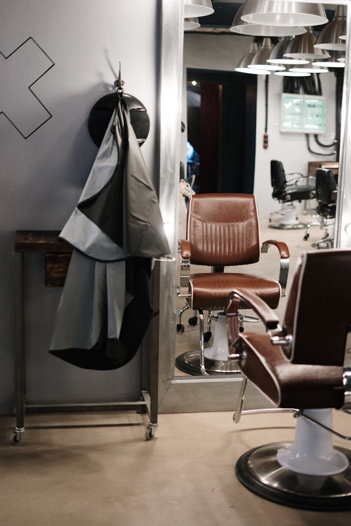 Home Contemporary barbershop interior showcasing stylish chairs and mirrors ready for clients.